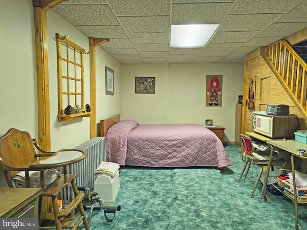 a bedroom with a bed a table and chair