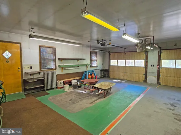 a backyard of a house with yard table and chairs