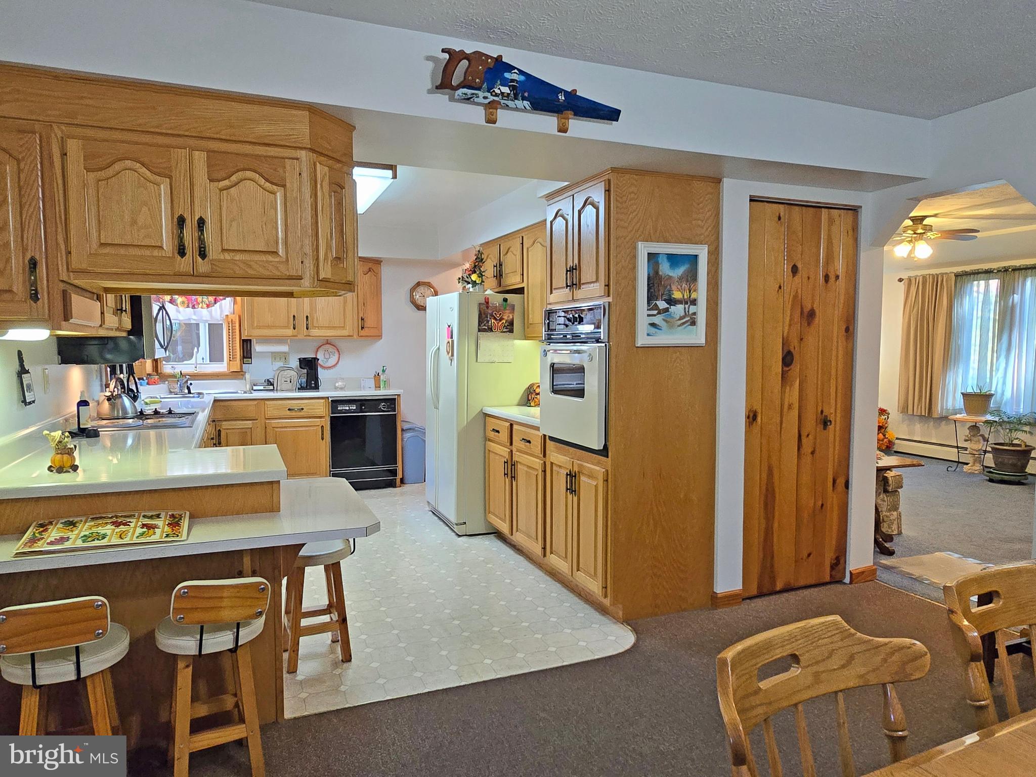 162 Avilton Road Lonaconing, MD 21539 - Photo 5 of 49 a kitchen with stainless steel appliances granite countertop a refrigerator a sink dishwasher a dining table and chairs with wooden floor
