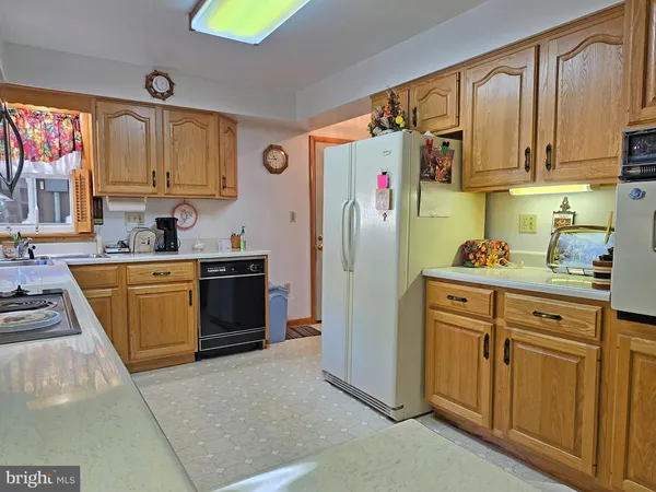 a kitchen with stainless steel appliances granite countertop a refrigerator sink and cabinets