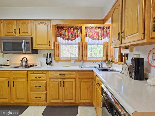 a kitchen with stainless steel appliances a sink a stove and a microwave