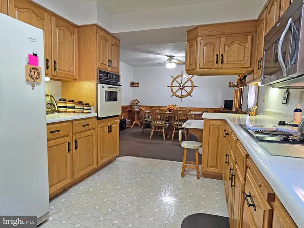 a kitchen with stainless steel appliances granite countertop a sink dishwasher stove and cabinets