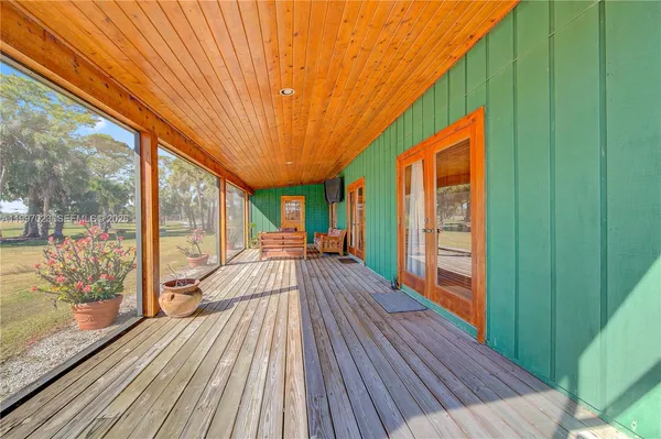 a view of a patio with table and chairs with wooden fence