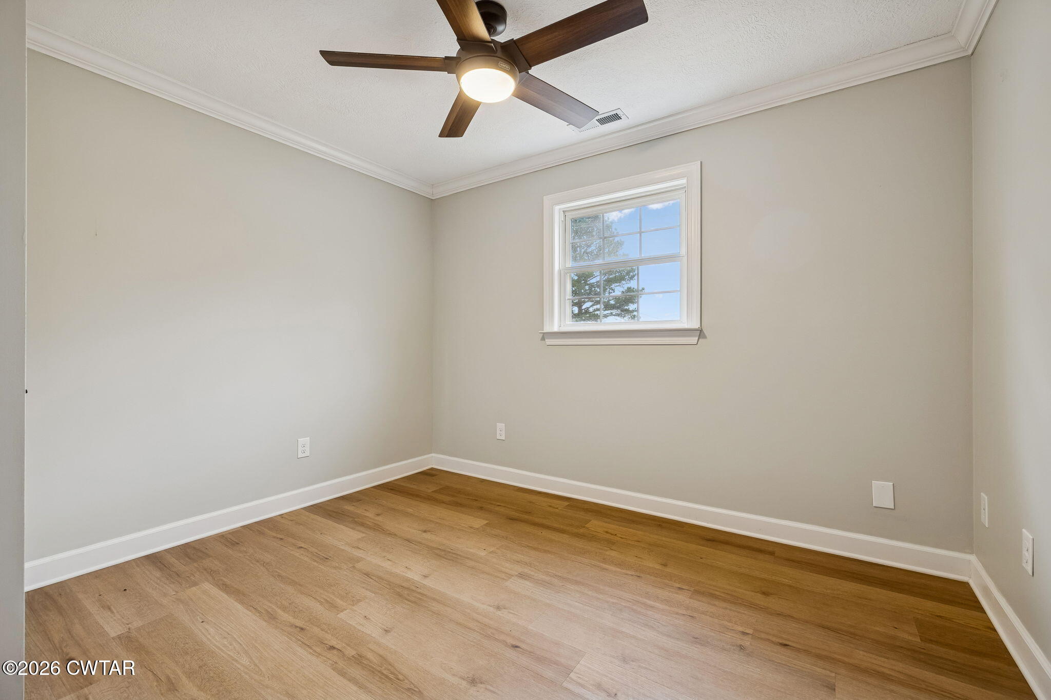 123 Walnut Hill Road Bells, TN 38006 - Photo 33 of 61 an empty room with a window and a ceiling fan