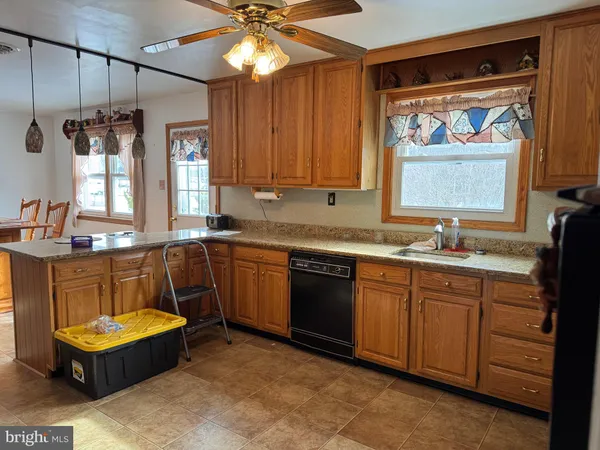 a kitchen with a sink cabinets and window