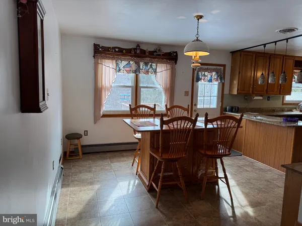 a dining room with furniture a chandelier and window