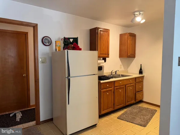 a kitchen with a refrigerator and a sink