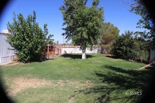 1241 South Mahan Street Ridgecrest, CA 93555 - Photo 18 of 28 a view of a house with a backyard