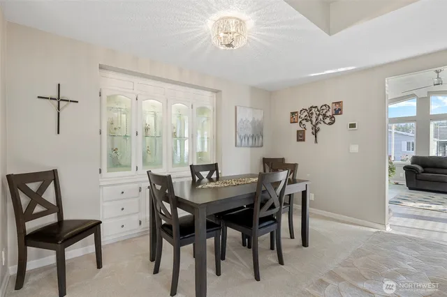 a view of a dining room with furniture and a chandelier