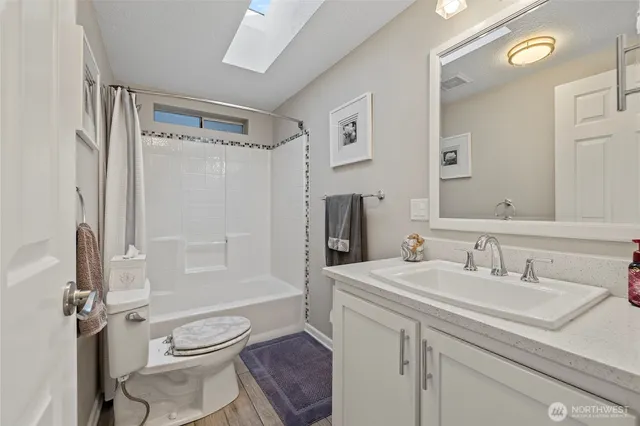 a bathroom with a sink toilet a shower and a mirror