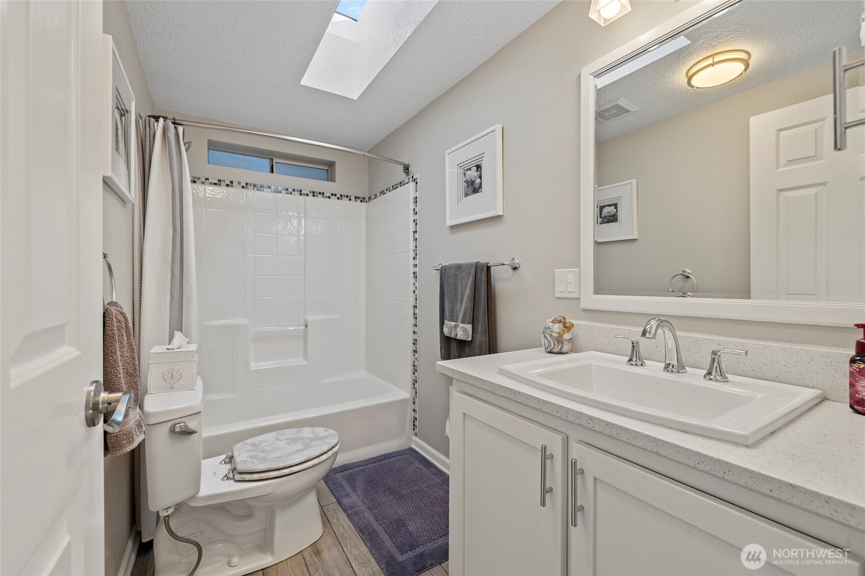 2610 East Section Street, Unit 12 Mount Vernon, WA 98274 - Photo 18 of 39 a bathroom with a sink toilet a shower and a mirror