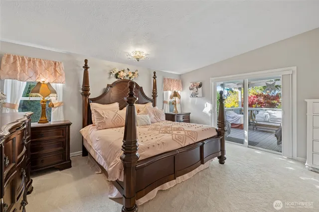 a bed room with a bed and a painting on the wall