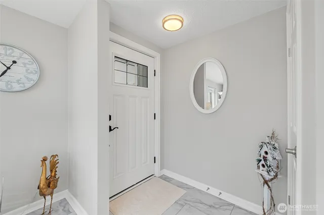 a view of a livingroom with wooden floor and a white wall