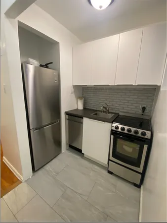 a stove top oven sitting inside of a kitchen