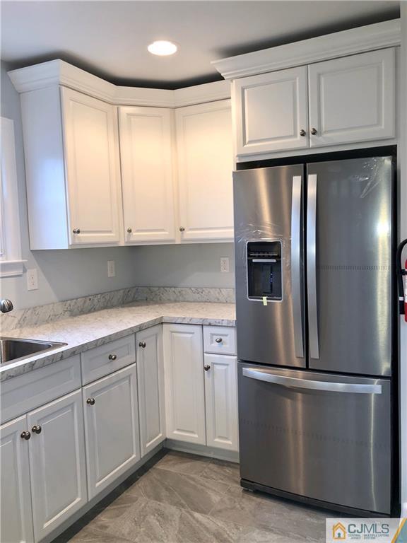 27 Forrest Street Iselin, NJ 08830 - Photo 4 of 12 a kitchen with cabinets and stainless steel appliances