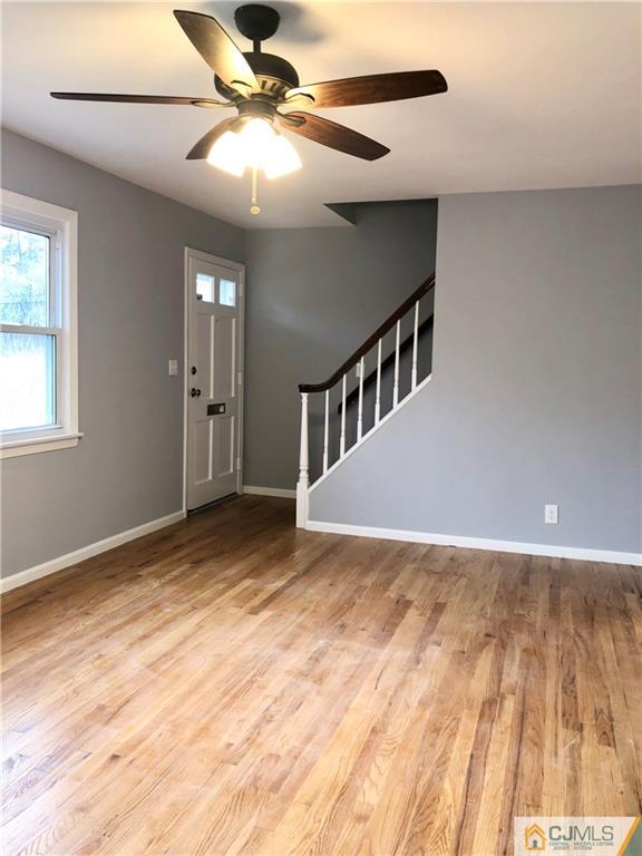 27 Forrest Street Iselin, NJ 08830 - Photo 8 of 12 a view of an empty room with window and chandelier fan