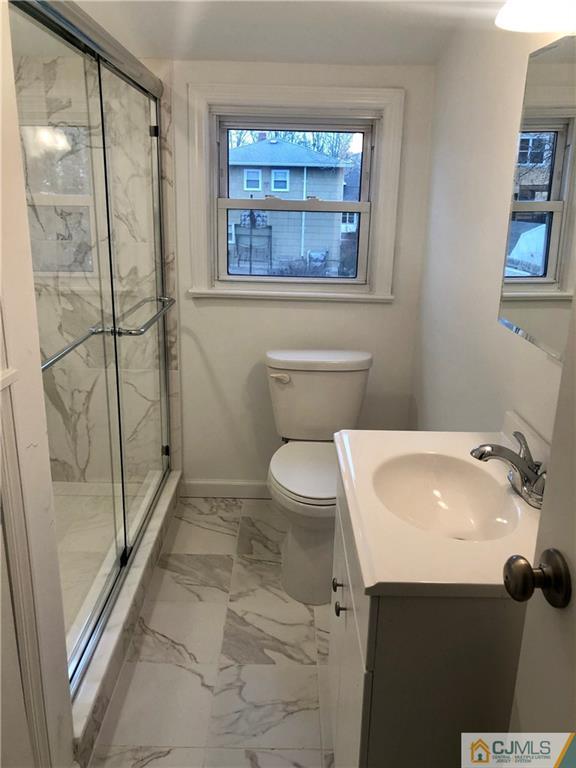 27 Forrest Street Iselin, NJ 08830 - Photo 9 of 12 a bathroom with a sink toilet and shower