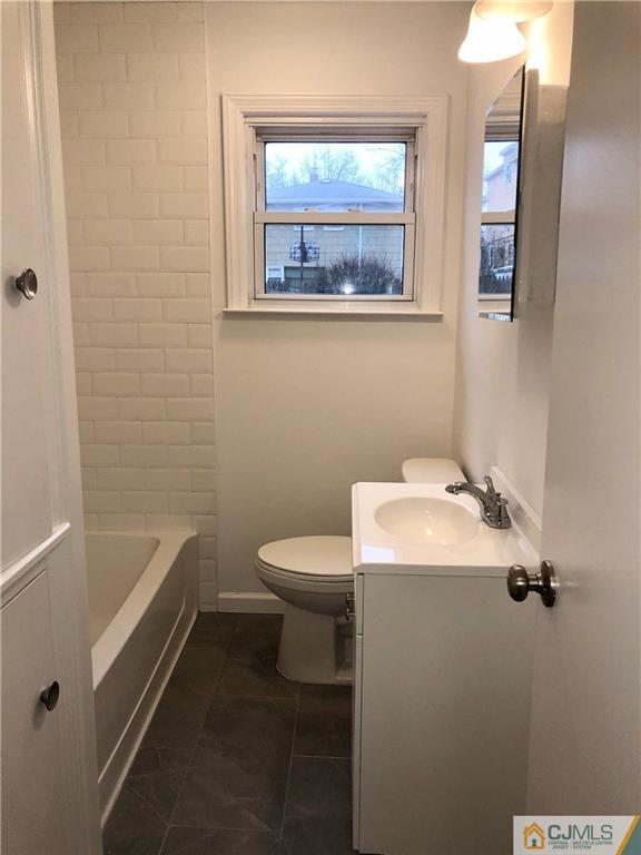 27 Forrest Street Iselin, NJ 08830 - Photo 10 of 12 a bathroom with a sink and mirror with toilet