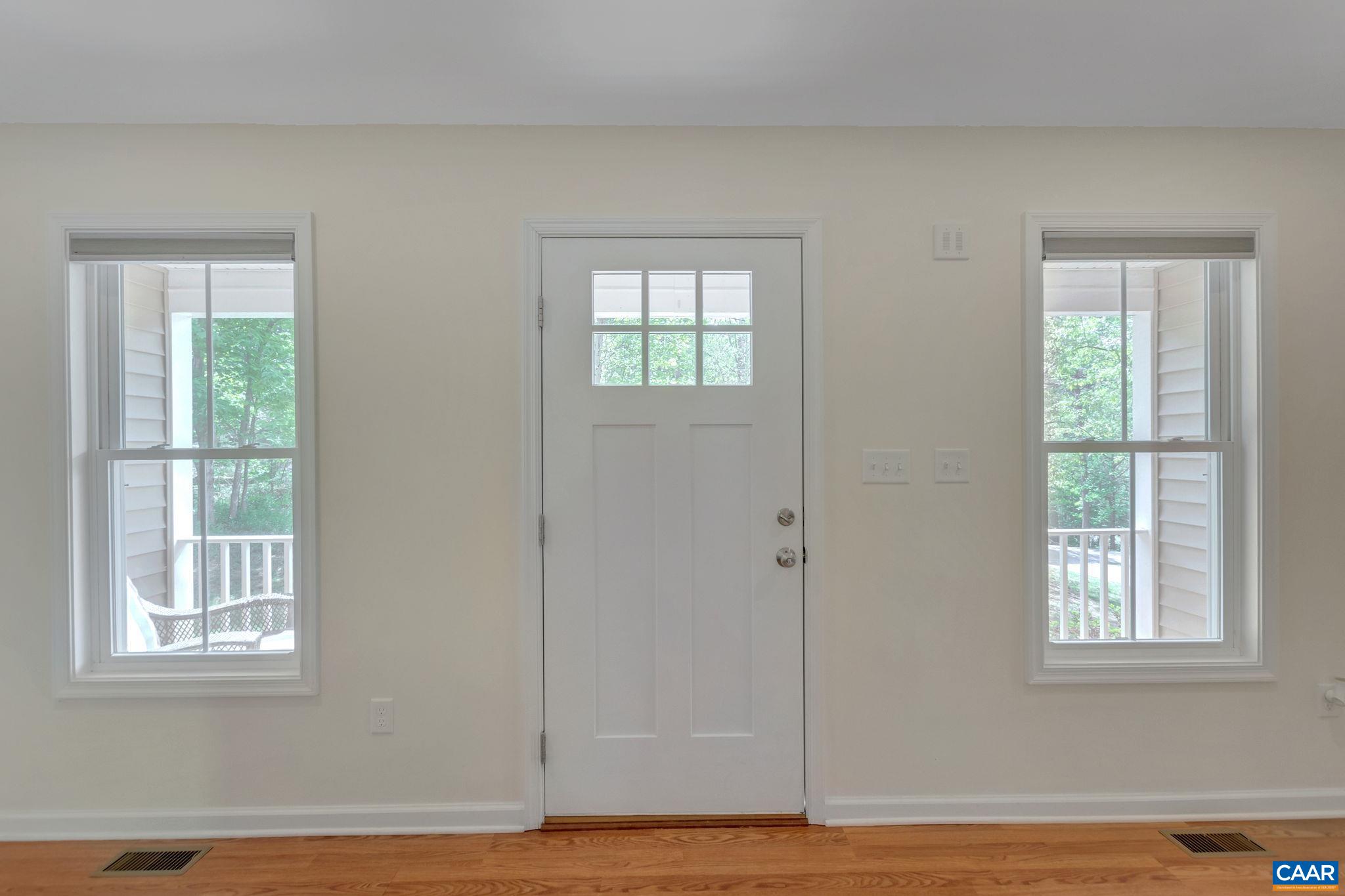171 Goldenrod Road Ruckersville, VA 22968 - Photo 13 of 45 a view of an empty room with wooden floor and a window