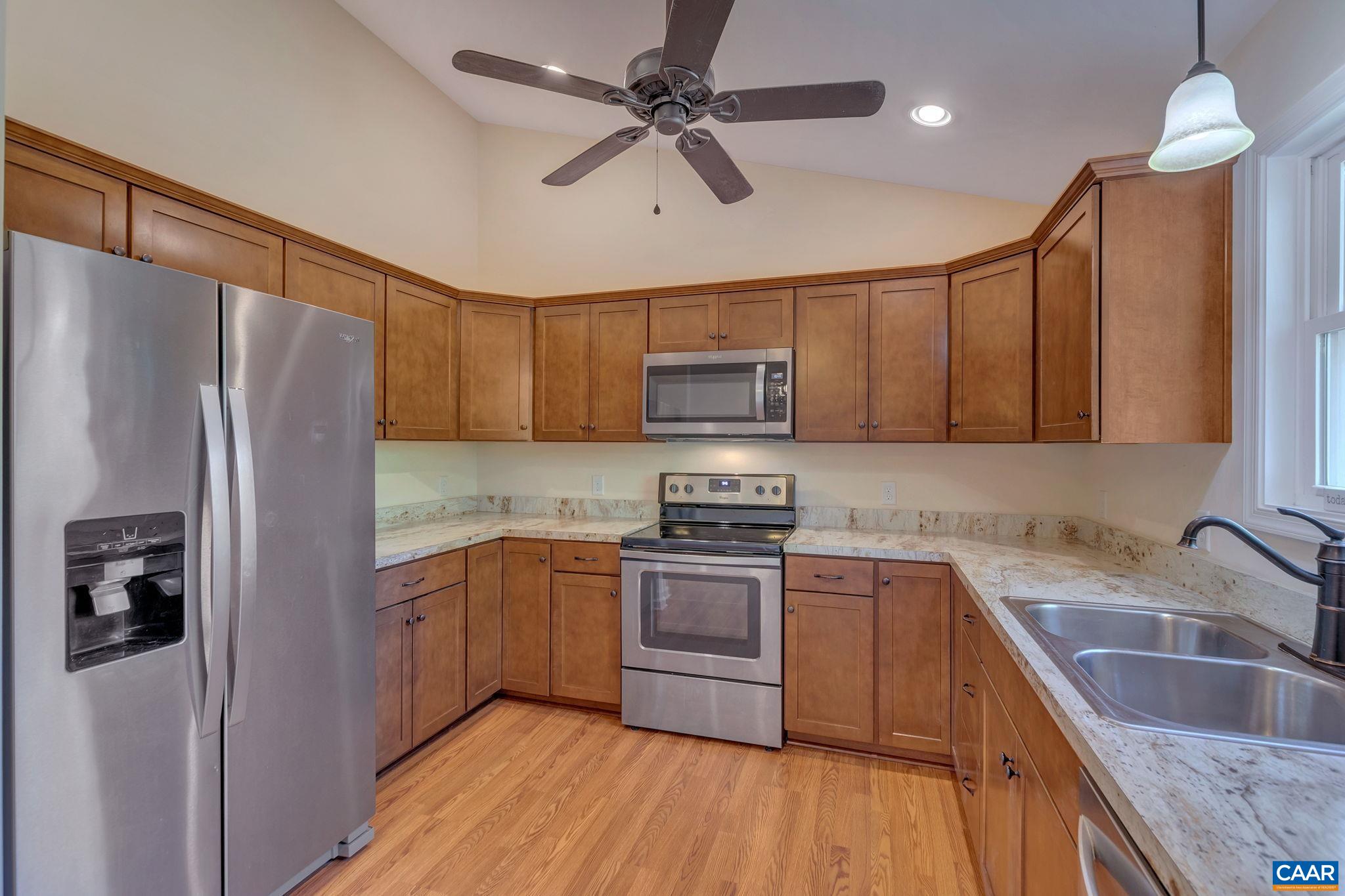 171 Goldenrod Road Ruckersville, VA 22968 - Photo 22 of 45 a kitchen with kitchen island granite countertop a sink stainless steel appliances and cabinets