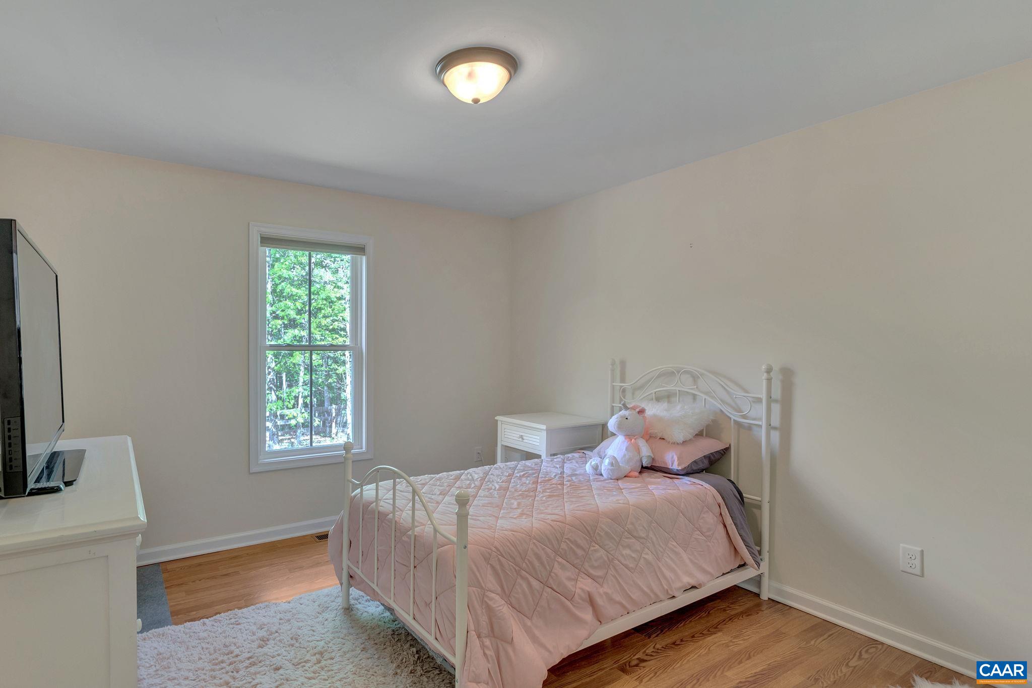 171 Goldenrod Road Ruckersville, VA 22968 - Photo 32 of 45 a bedroom with a bed and a window
