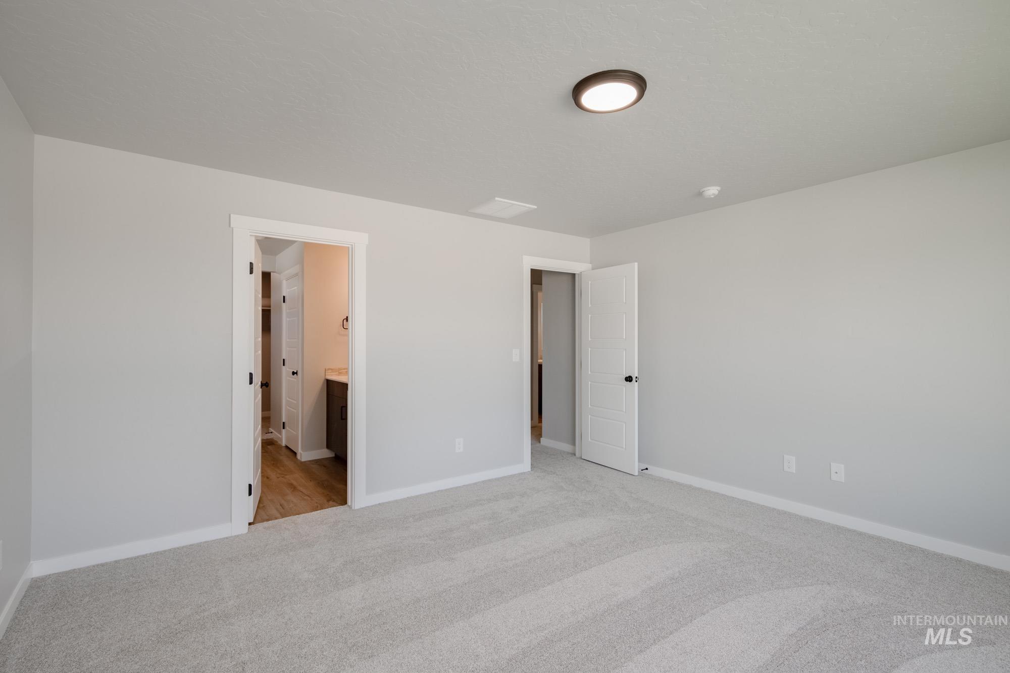 5328 Castleton Avenue Nampa, ID 83686 - Photo 18 of 26 Unfurnished bedroom featuring light colored carpet and ensuite bath