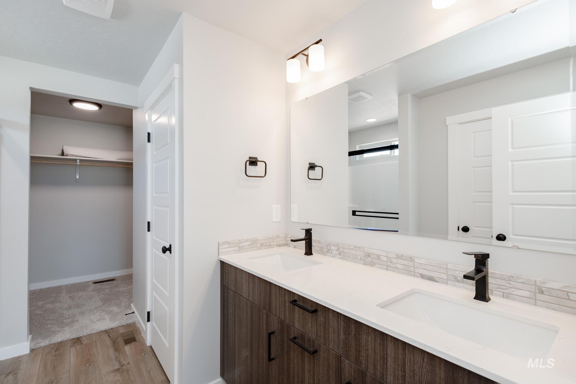 5328 Castleton Avenue Nampa, ID 83686 - Photo 20 of 26 Full bath with wood finished floors, double vanity, a spacious closet, and backsplash