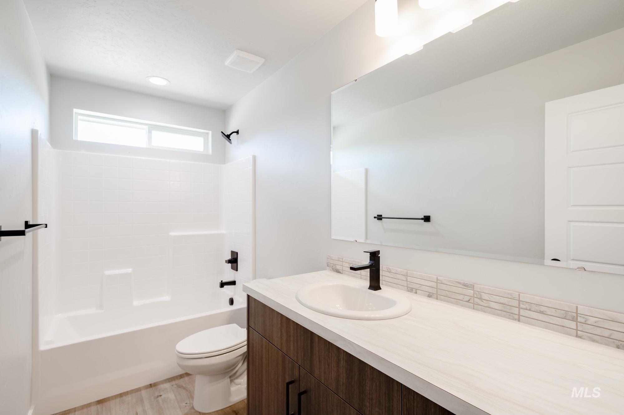 5328 Castleton Avenue Nampa, ID 83686 - Photo 22 of 26 Full bathroom with vanity, shower / tub combination, and wood finished floors