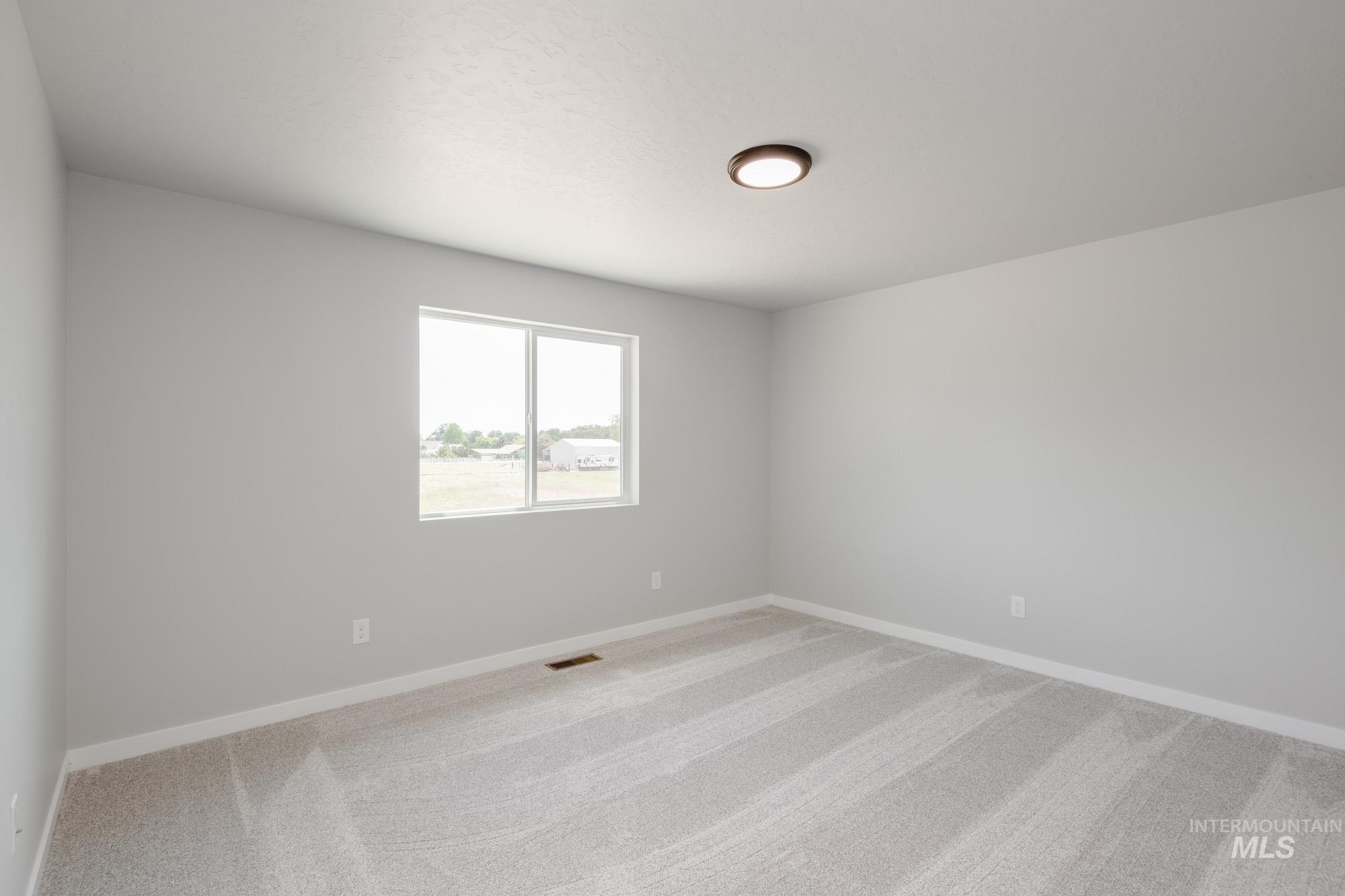 5328 Castleton Avenue Nampa, ID 83686 - Photo 23 of 26 Carpeted spare room featuring baseboards