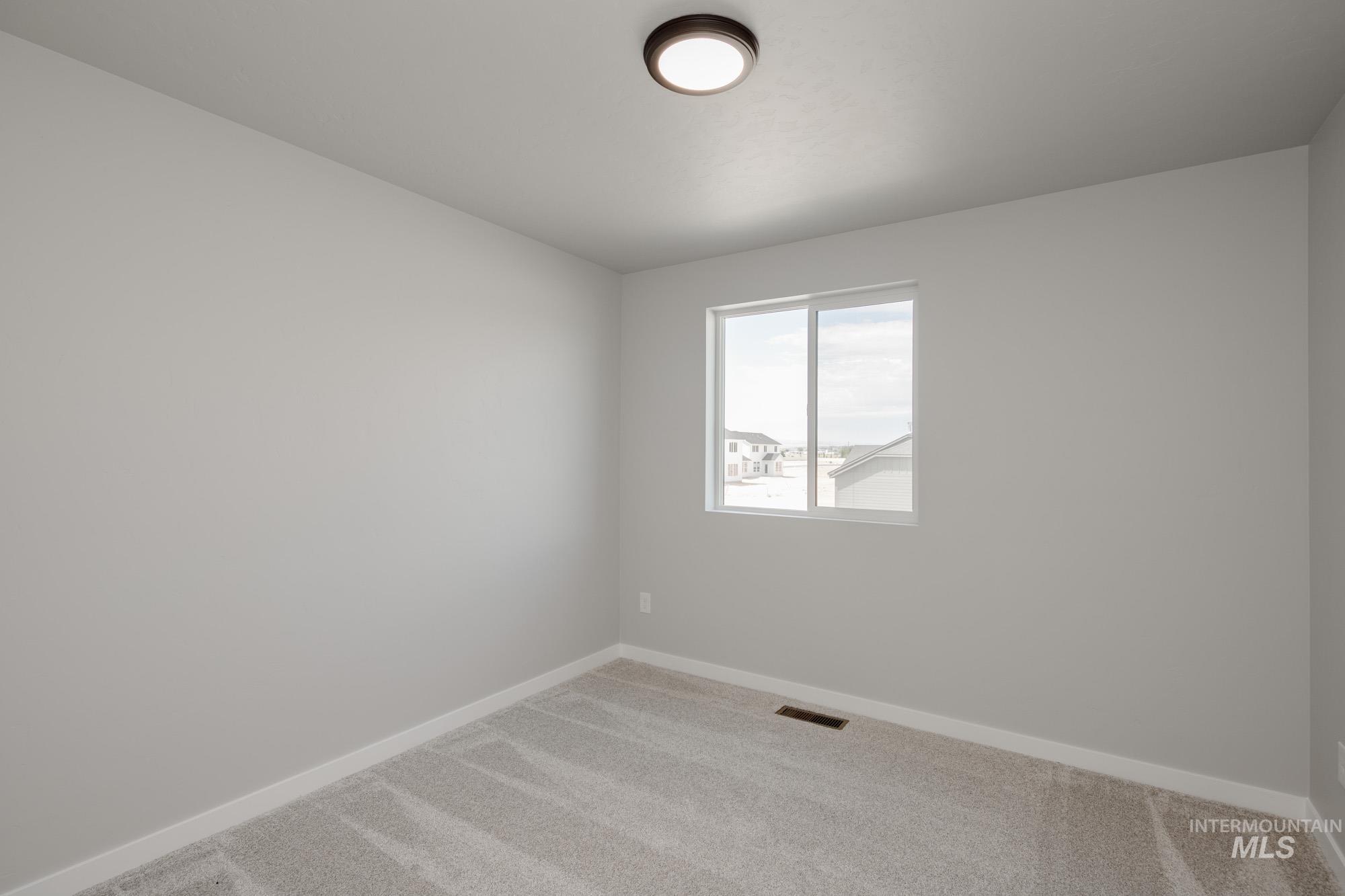 5328 Castleton Avenue Nampa, ID 83686 - Photo 25 of 26 Unfurnished room with light colored carpet and baseboards