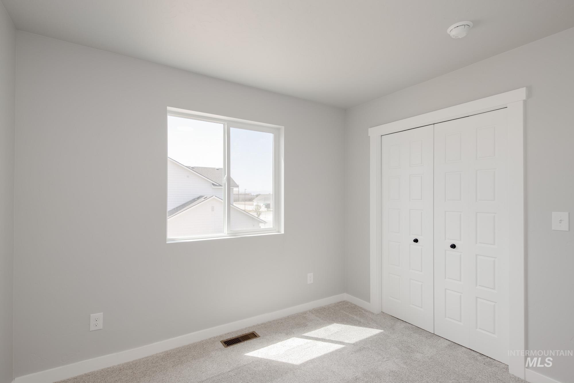 5328 Castleton Avenue Nampa, ID 83686 - Photo 26 of 26 Unfurnished bedroom with light colored carpet and a closet