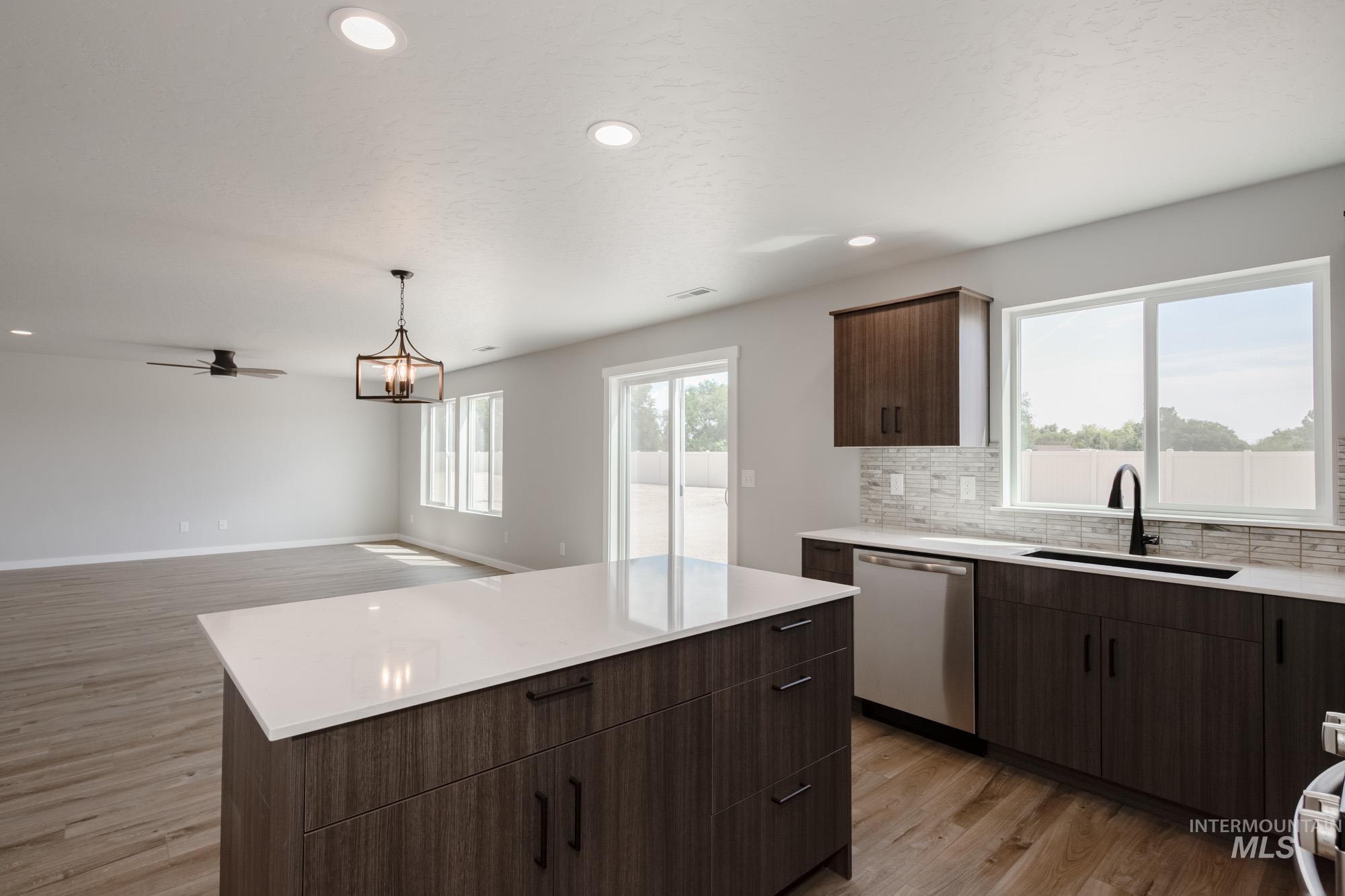 5328 Castleton Avenue Nampa, ID 83686 - Photo 6 of 26 Kitchen featuring light wood-style floors, tasteful backsplash, recessed lighting, stainless steel dishwasher, and light countertops