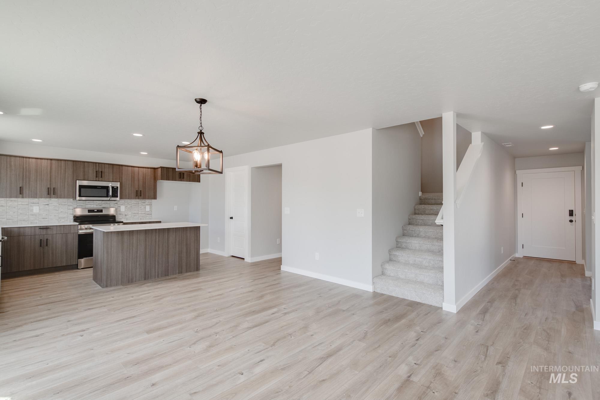 5328 Castleton Avenue Nampa, ID 83686 - Photo 10 of 26 Kitchen featuring recessed lighting, stainless steel appliances, backsplash, light wood-style floors, and a center island