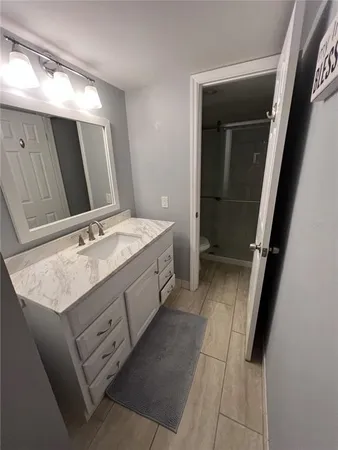 a bathroom with a double vanity sink and mirror