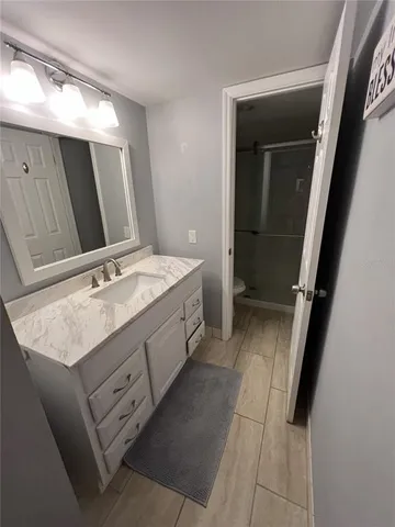 a bathroom with a double vanity sink and mirror