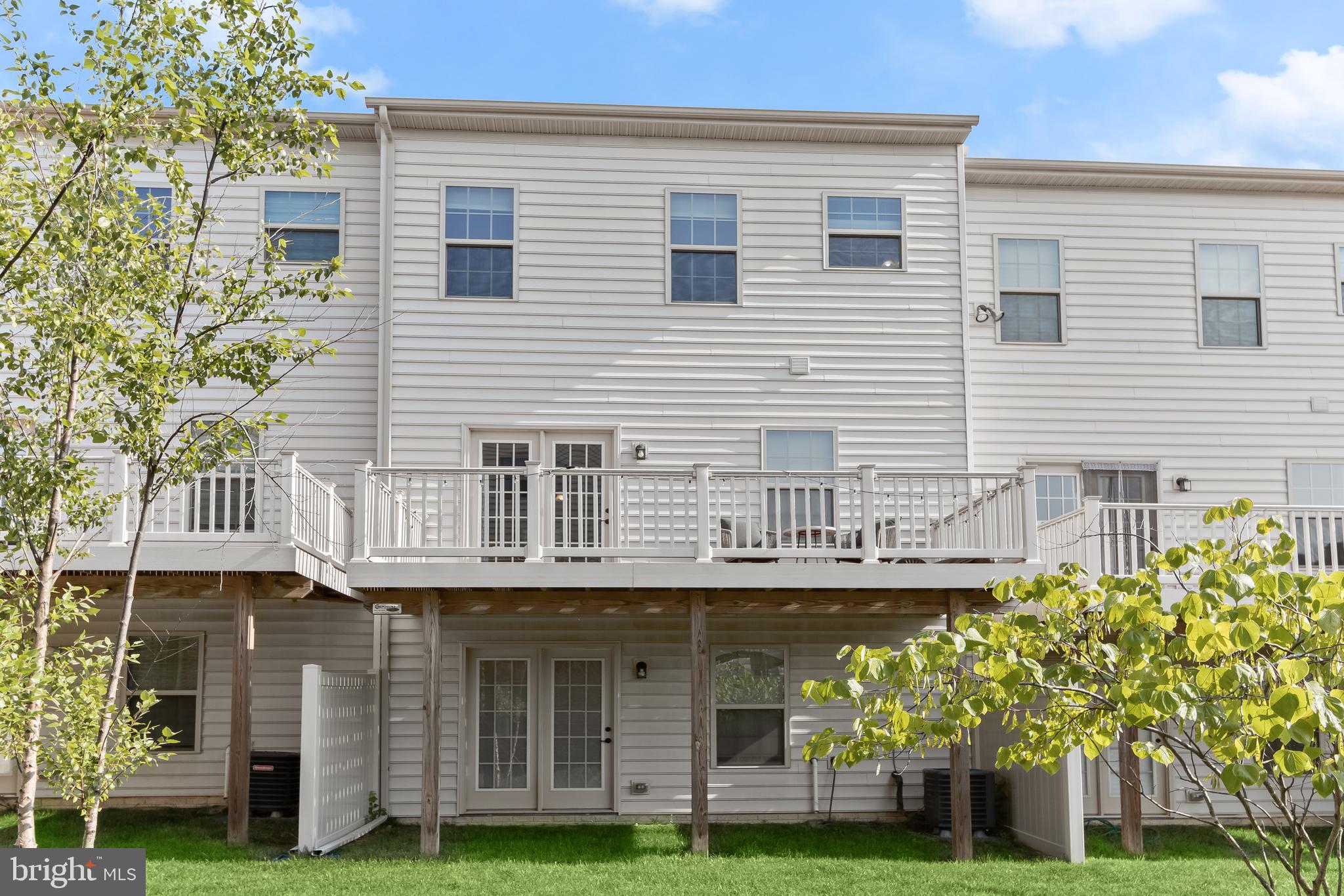 14311 Ridge View Lane Laurel, MD 20707 - Photo 26 of 29 a front view of a house with a garden and plants
