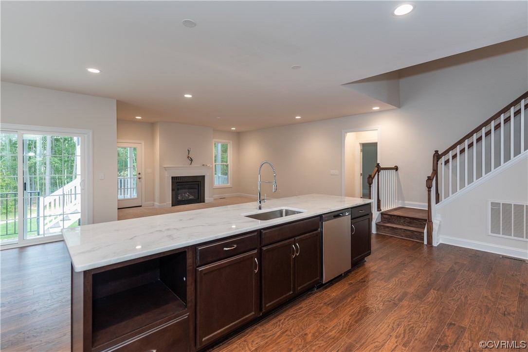 9331 Widthby Road Chesterfield, VA 23832 - Photo 5 of 29 a kitchen with stainless steel appliances granite countertop a stove a sink and a wooden floors