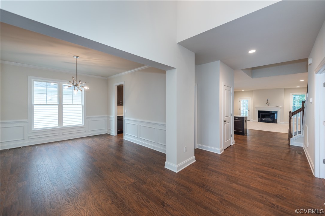 9331 Widthby Road Chesterfield, VA 23832 - Photo 10 of 29 a view of empty room with wooden floor and kitchen view
