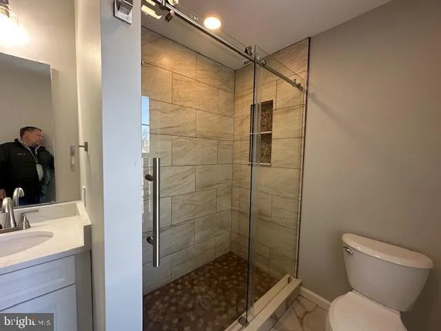 a bathroom with a shower a toilet and sink