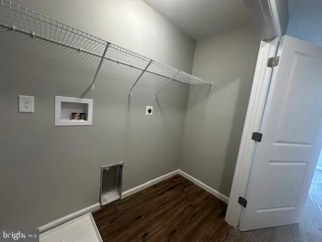 a view of a room with wooden floor and white walls