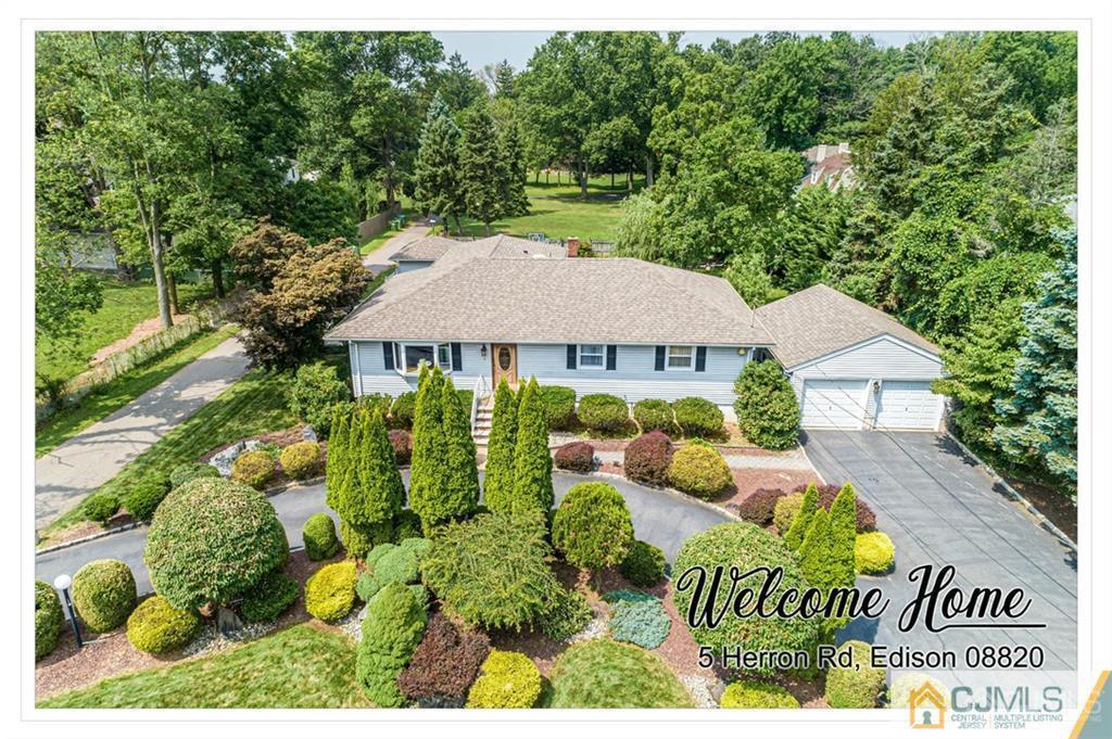 5 Herron Road Edison, NJ 08820 - Photo 1 of 42 a view of an house with backyard space and garden