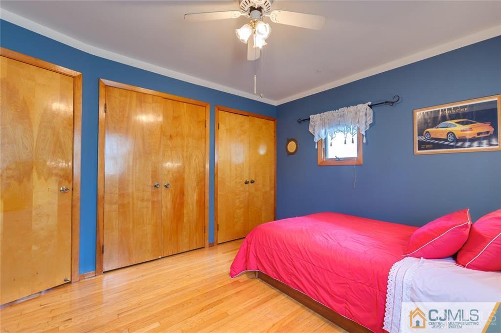 5 Herron Road Edison, NJ 08820 - Photo 20 of 42 a bedroom with a bed and a chandelier