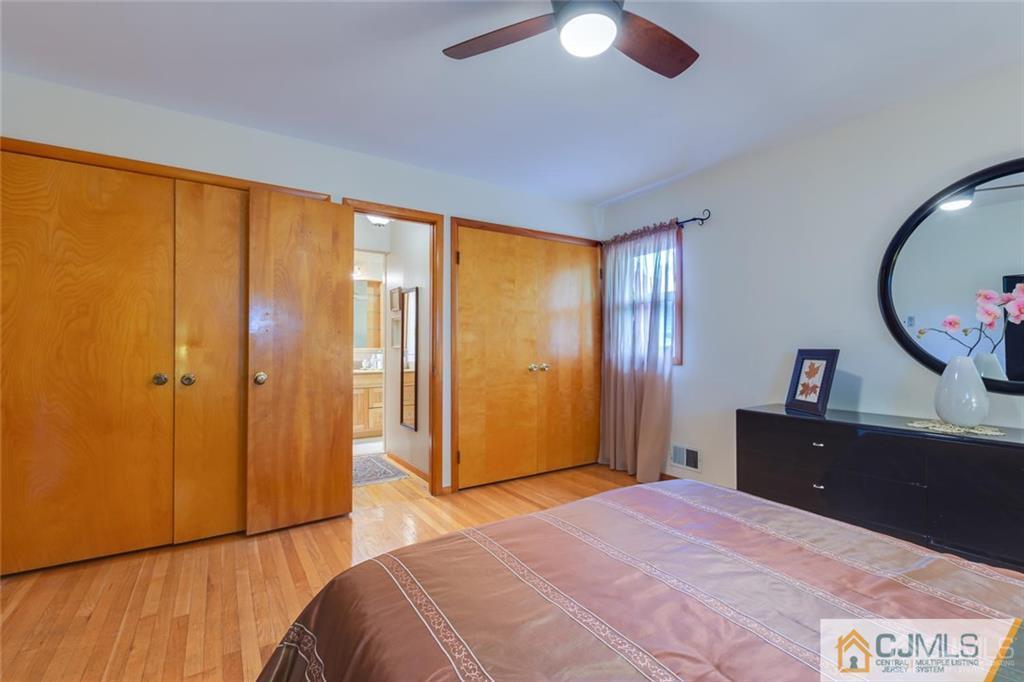 5 Herron Road Edison, NJ 08820 - Photo 23 of 42 a bedroom with a bed and a dresser