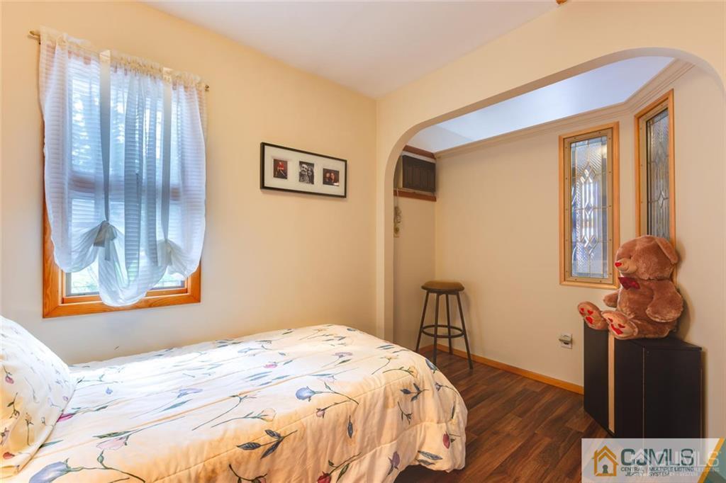 5 Herron Road Edison, NJ 08820 - Photo 25 of 42 a bedroom with a bed and wooden floor
