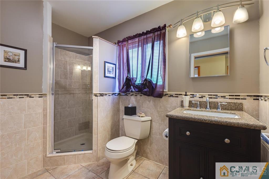 5 Herron Road Edison, NJ 08820 - Photo 26 of 42 a bathroom with a sink a toilet and shower