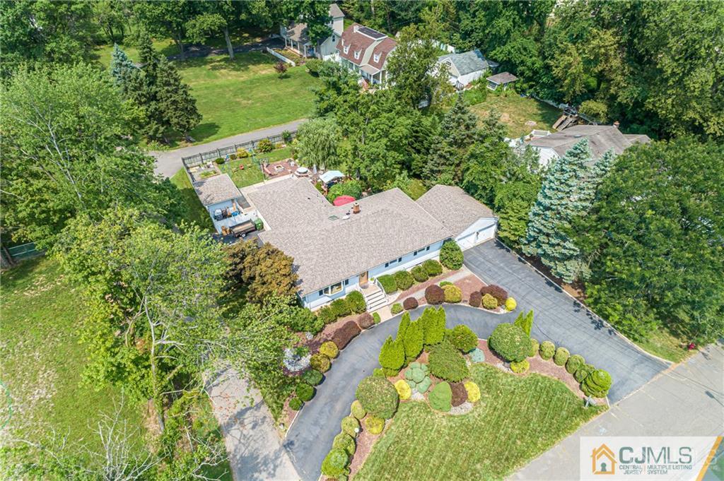 5 Herron Road Edison, NJ 08820 - Photo 3 of 42 an aerial view of a house with a yard and greenery