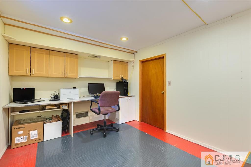 5 Herron Road Edison, NJ 08820 - Photo 33 of 42 a workspace with a computer on the desk chairs wooden cabinets