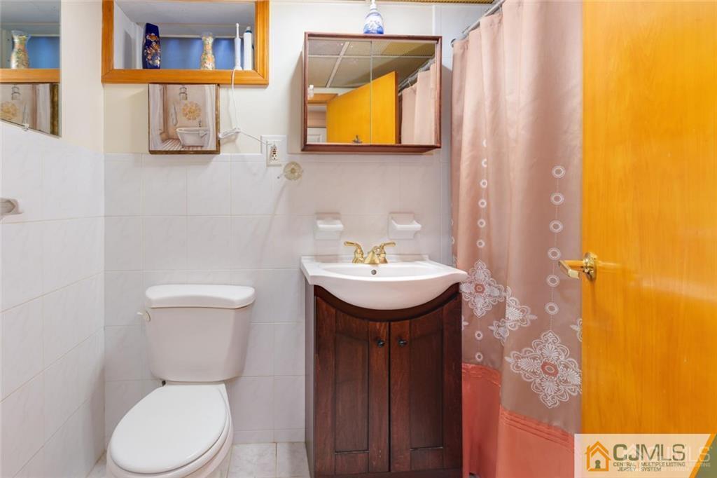 5 Herron Road Edison, NJ 08820 - Photo 34 of 42 a bathroom with a toilet sink and mirror