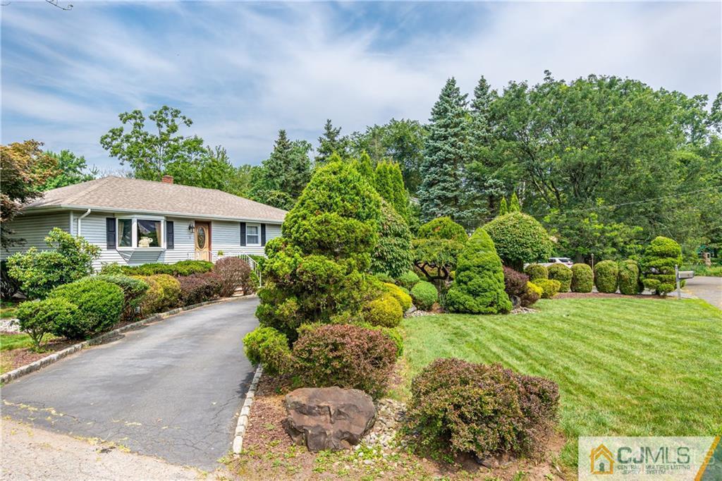 5 Herron Road Edison, NJ 08820 - Photo 8 of 42 a front view of a house with a yard and potted plants