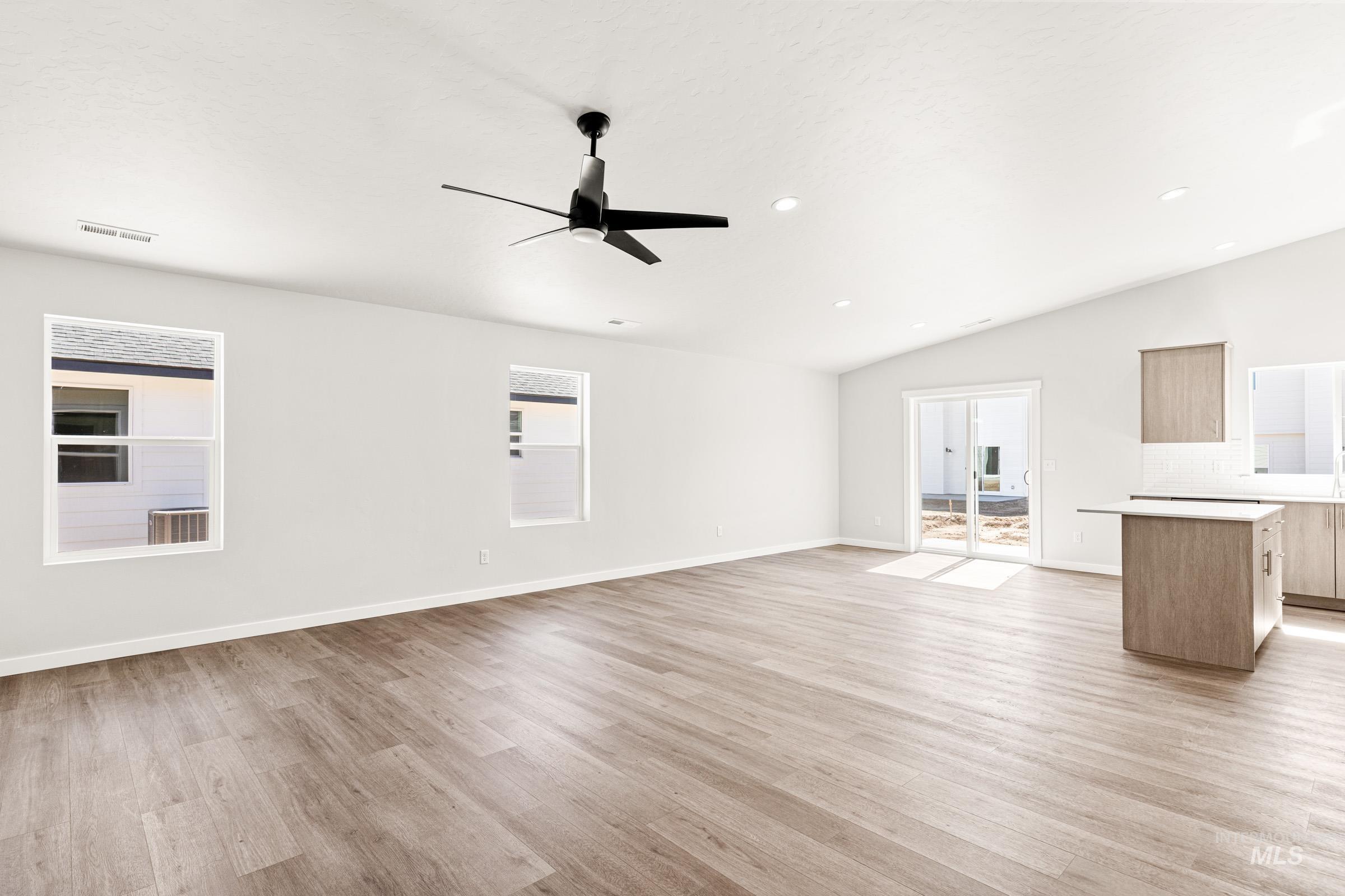 1077 West Jasper Street Meridian, ID 83642 - Photo 9 of 19 Spacious interior featuring wood-finish flooring, vaulted ceilings, and recessed lighting
